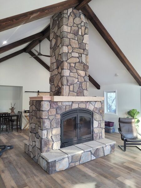 Natural stone fireplace in a vaulted living room