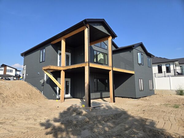 Dark stucco two-storey house with timber posts